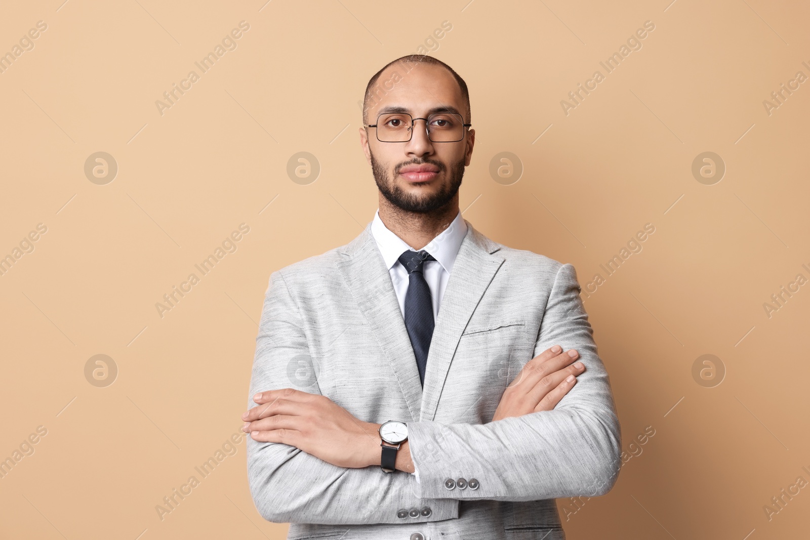 Photo of Portrait of businessman in glasses on beige background