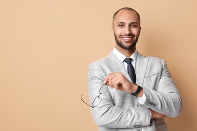 Photo of Portrait of businessman with glasses on beige background, space for text