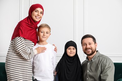 Photo of Happy Muslim family spending time together at home