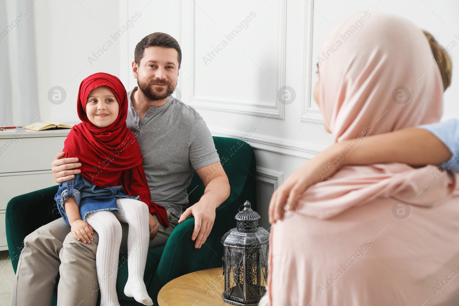 Photo of Happy Muslim family spending time together at home