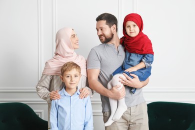 Photo of Happy Muslim family spending time together at home