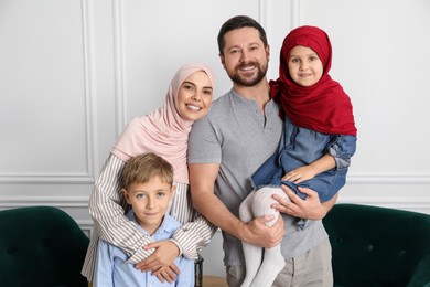 Photo of Happy Muslim family spending time together at home