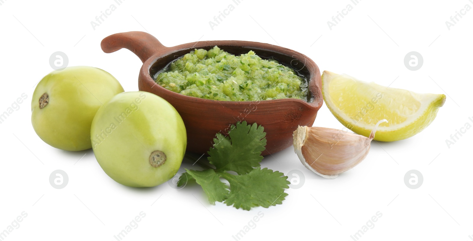 Photo of Delicious homemade green salsa and ingredients isolated on white