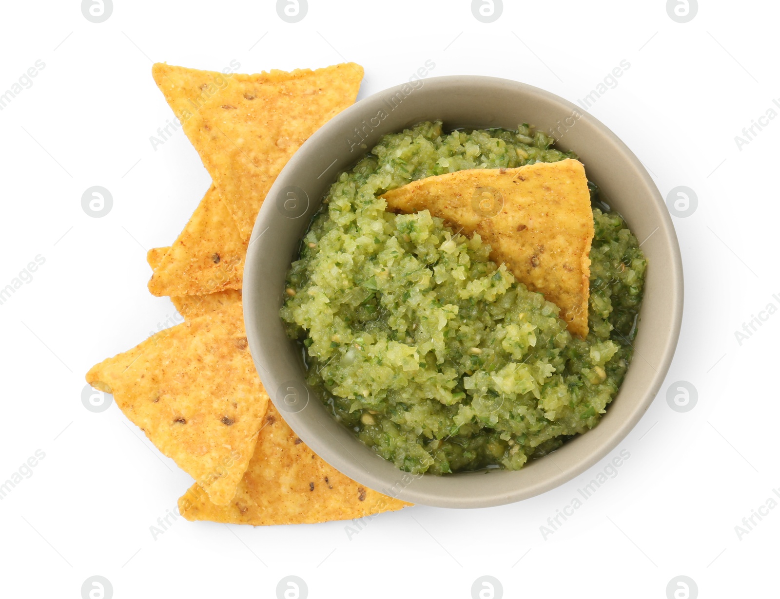 Photo of Delicious homemade green salsa with nachos isolated on white, top view