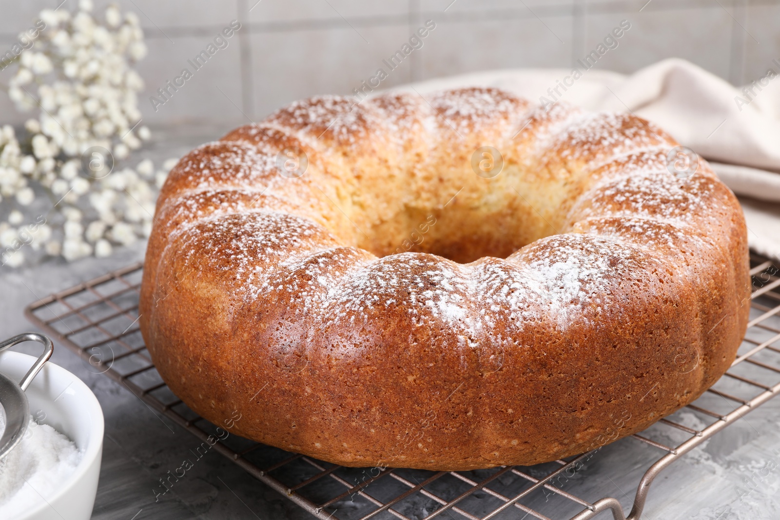 Photo of Freshly baked sponge cake on grey table, closeup