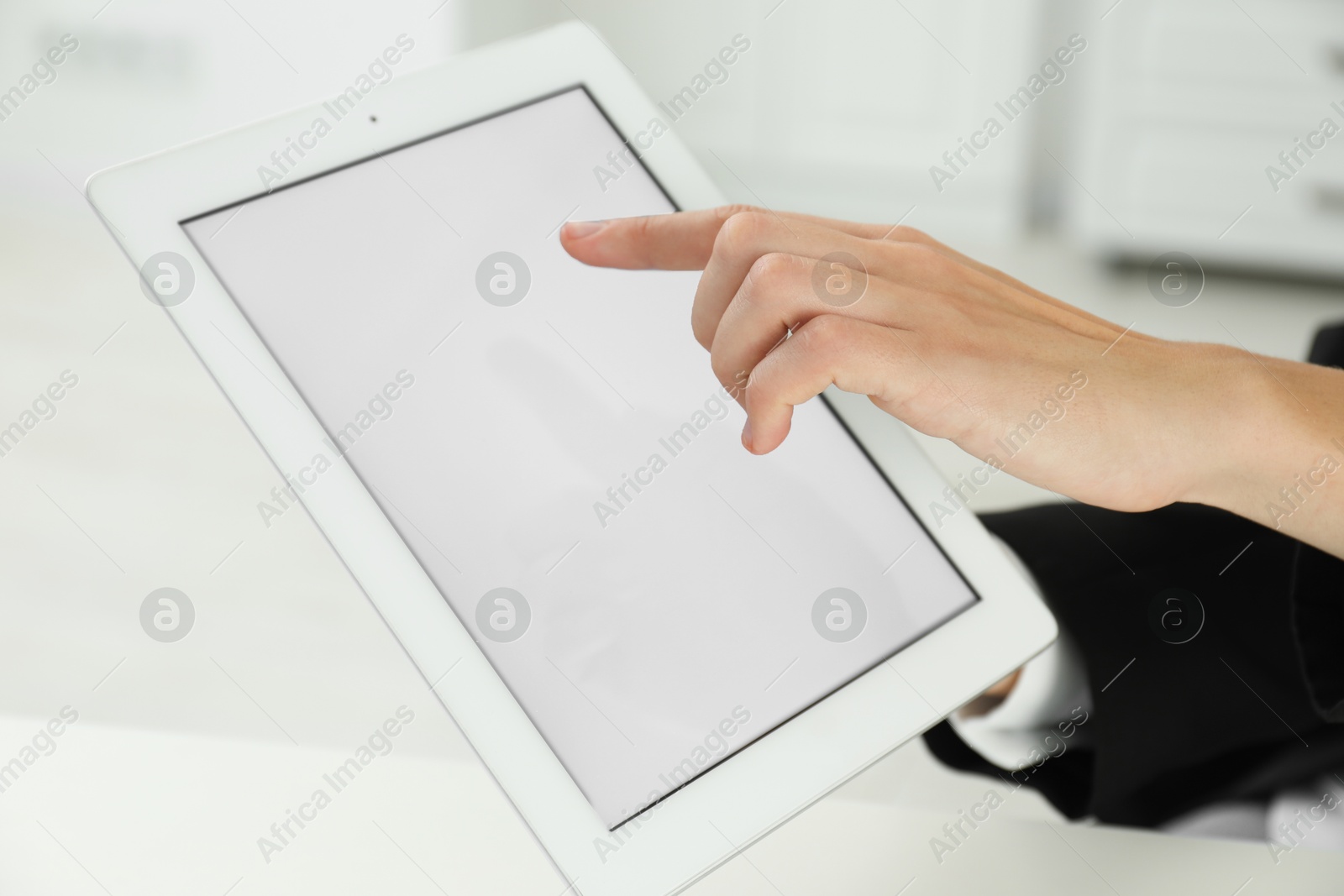 Photo of Businesswoman using tablet indoors, closeup. Modern technology