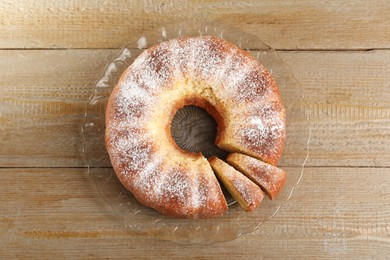 Photo of Freshly baked sponge cake on wooden table, top view