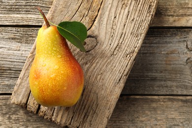 Photo of Ripe juicy pear on wooden table, top view