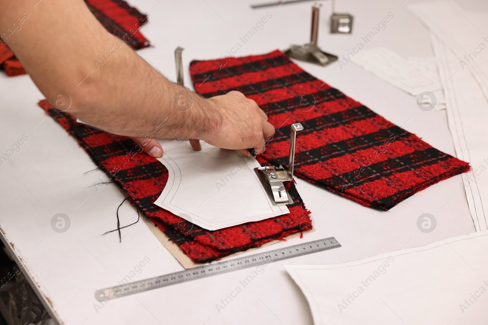 Photo of Man working at white table in professional workshop, closeup