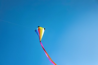 Photo of One colorful kite flying in sky on sunny day