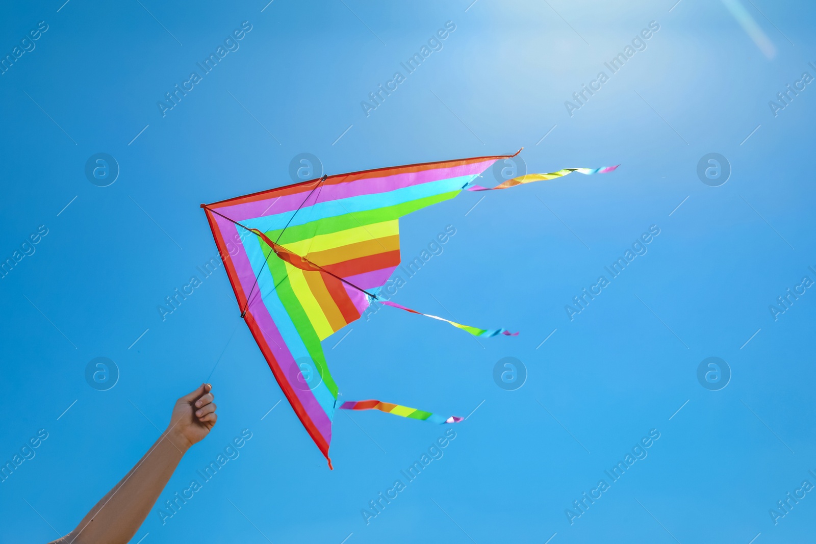 Man with colorful kite on sunny day, closeup Photo of Man with colorful kite on sunny day, closeup
