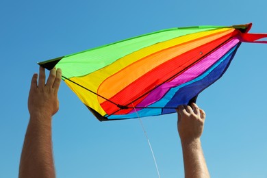 Photo of Man with kite against blue sky, closeup