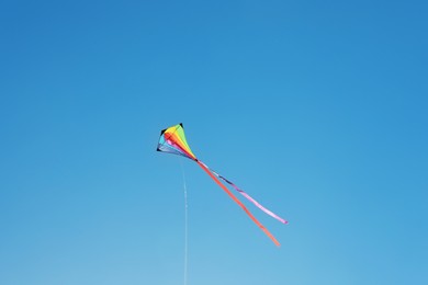 Photo of One colorful kite flying in blue sky