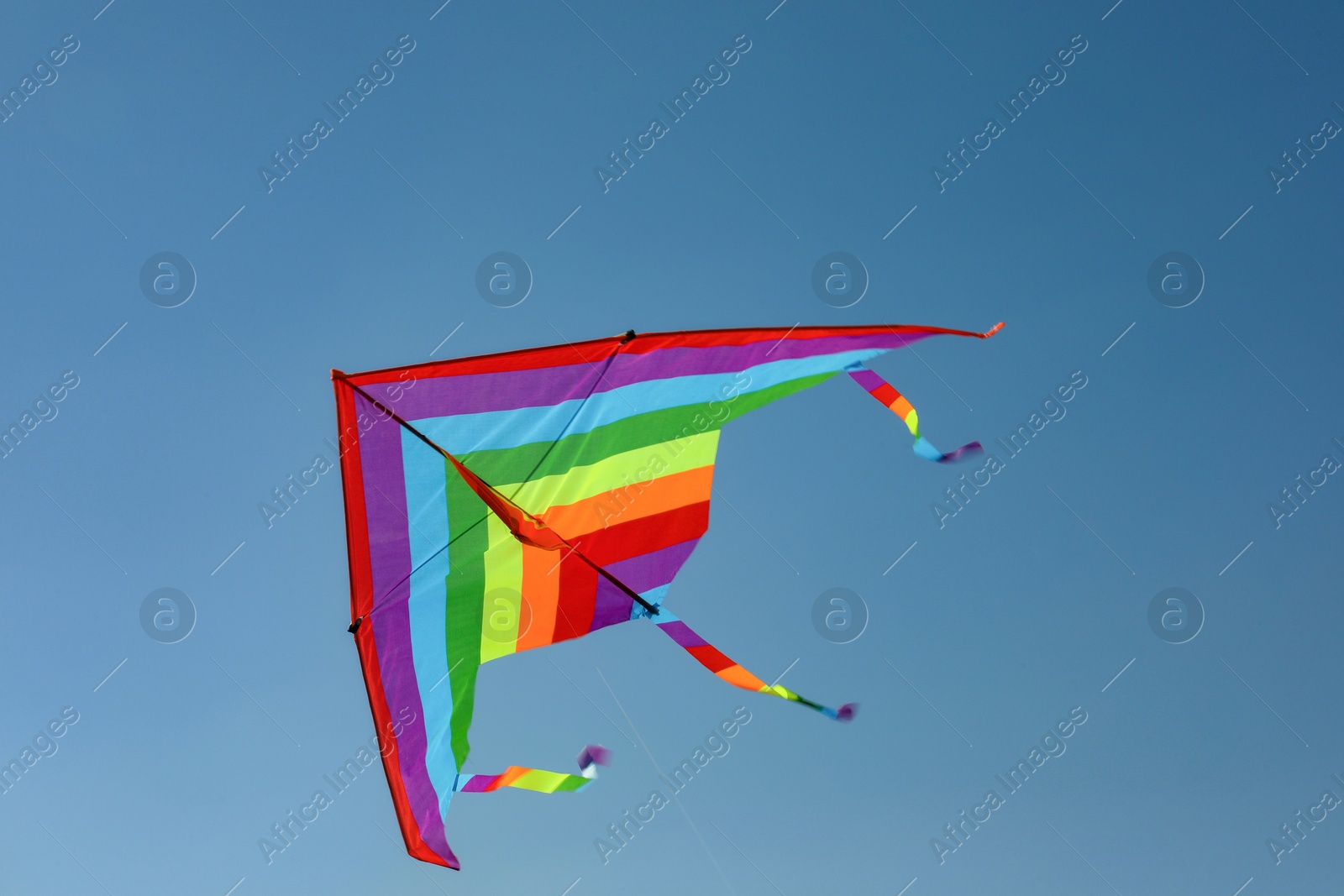 One colorful kite flying in blue sky Photo of One colorful kite flying in blue sky
