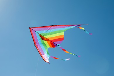 Photo of One colorful kite flying in blue sky