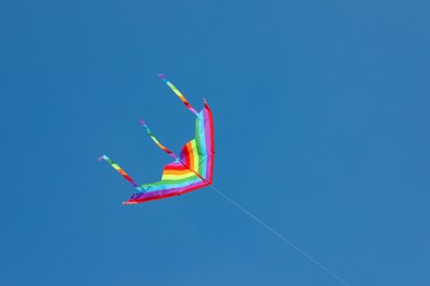 Photo of One colorful kite flying in blue sky