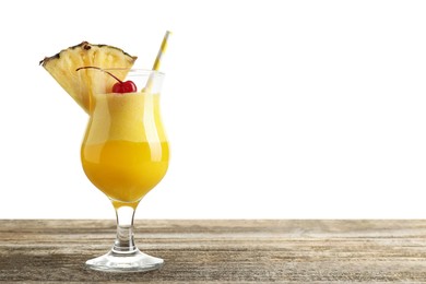 Photo of Tasty pineapple cocktail in glass on wooden table against white background