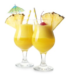 Photo of Tasty pineapple cocktail in glasses isolated on white