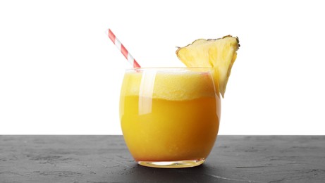 Photo of Tasty pineapple cocktail in glass on black table against white background