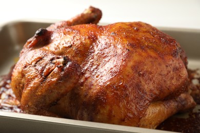 Photo of Delicious baked turkey in baking dish on light table, closeup