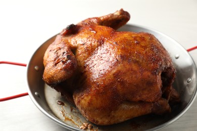 Photo of Delicious baked turkey in baking dish on light table, closeup