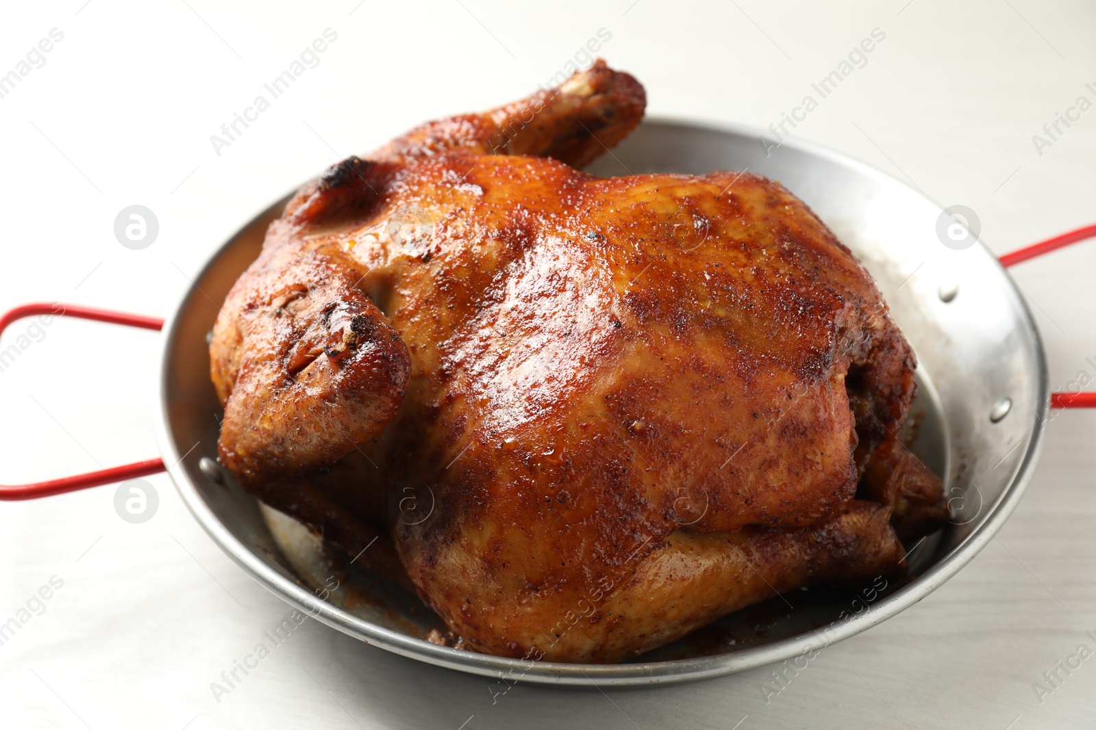 Photo of Delicious baked turkey in baking dish on light table, closeup