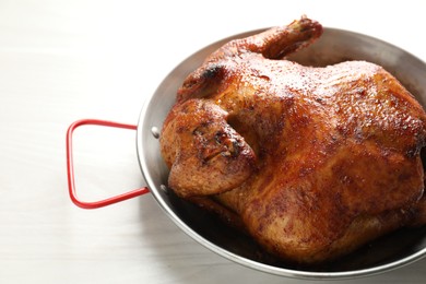 Photo of Delicious baked turkey in baking dish on light table, closeup