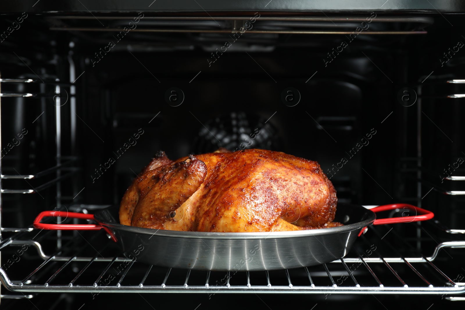 Photo of Delicious baked turkey in baking dish in oven