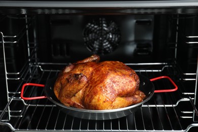 Photo of Delicious baked turkey in baking dish in oven