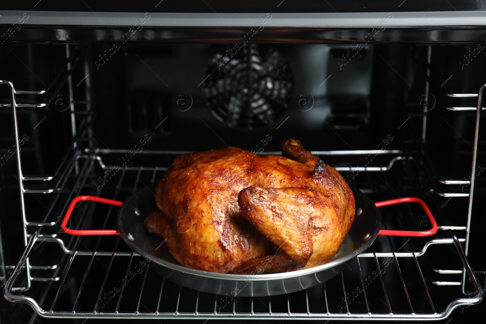 Photo of Delicious baked turkey in baking dish in oven