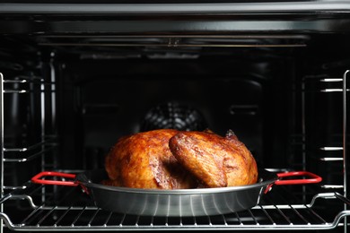 Photo of Delicious baked turkey in baking dish in oven