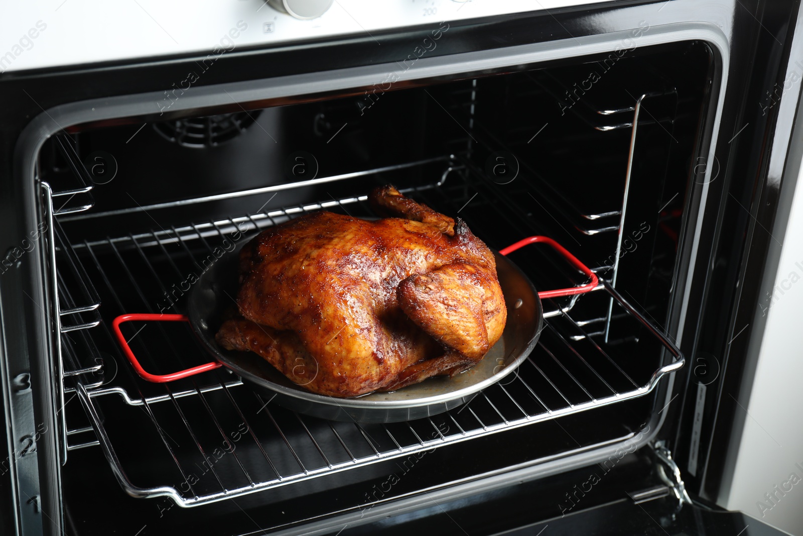 Photo of Delicious baked turkey in baking dish in oven