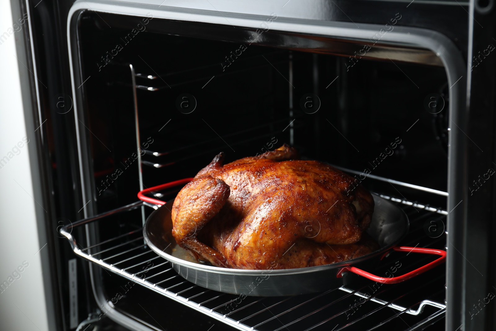 Photo of Delicious baked turkey in baking dish in oven