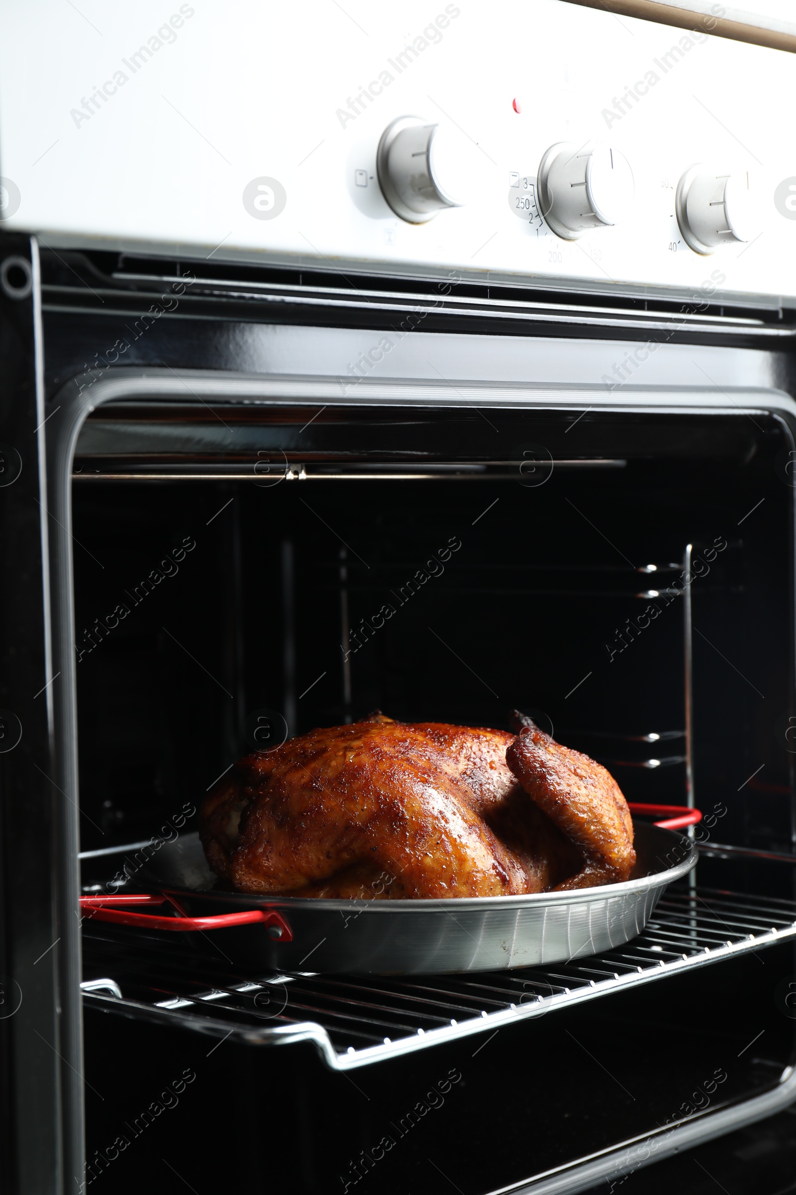 Photo of Delicious baked turkey in baking dish in oven