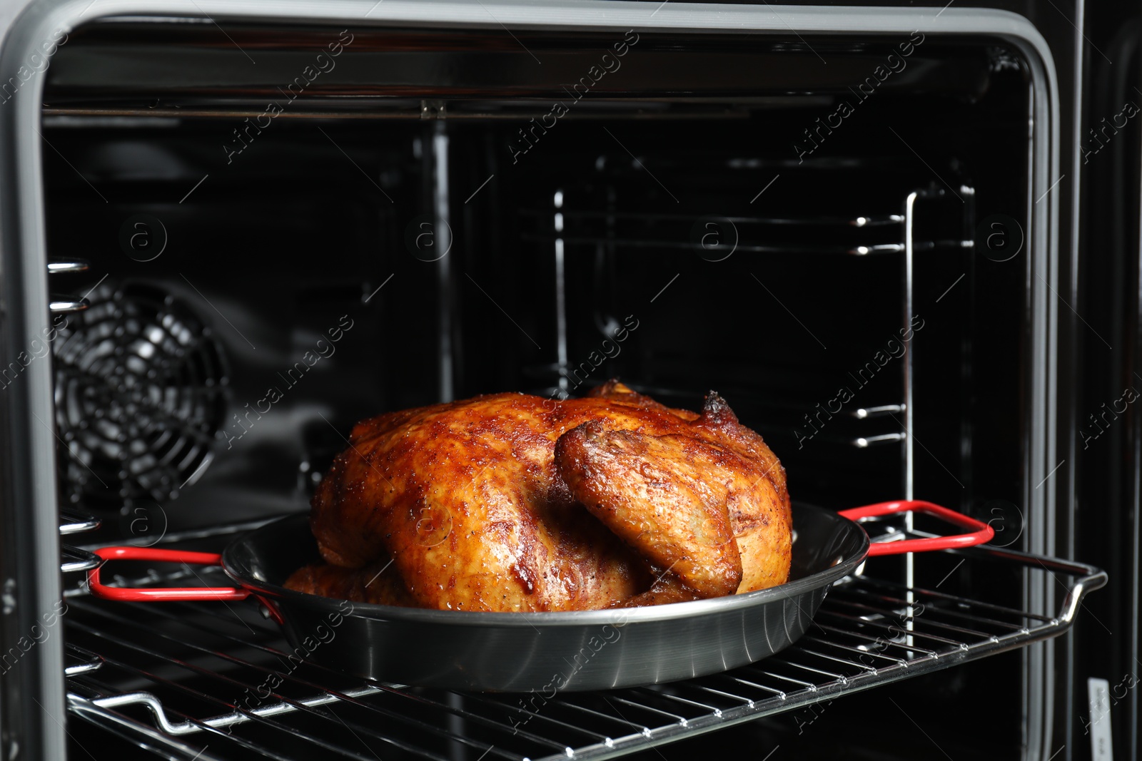 Photo of Delicious baked turkey in baking dish in oven