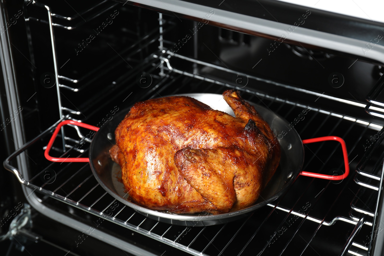 Photo of Delicious baked turkey in baking dish in oven