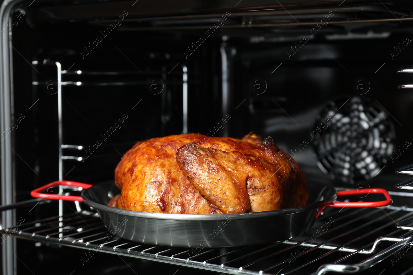 Photo of Delicious baked turkey in baking dish in oven