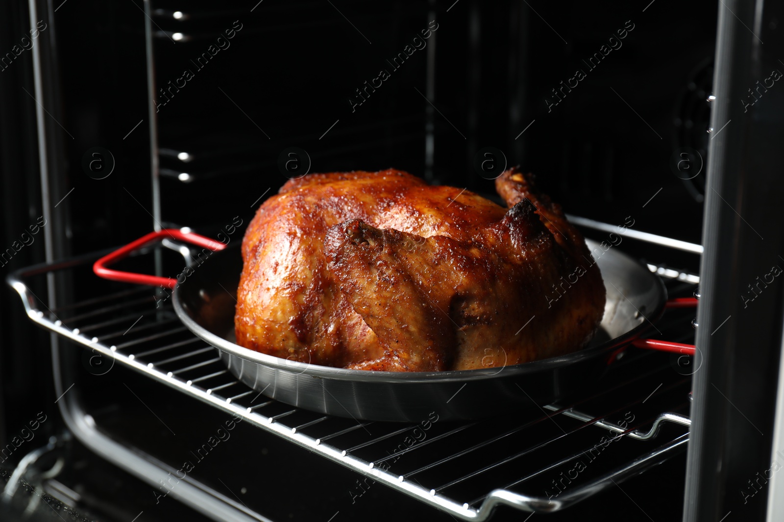 Photo of Delicious baked turkey in baking dish in oven