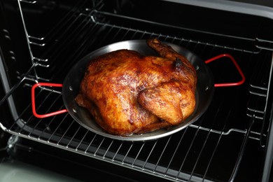 Photo of Delicious baked turkey in baking dish in oven