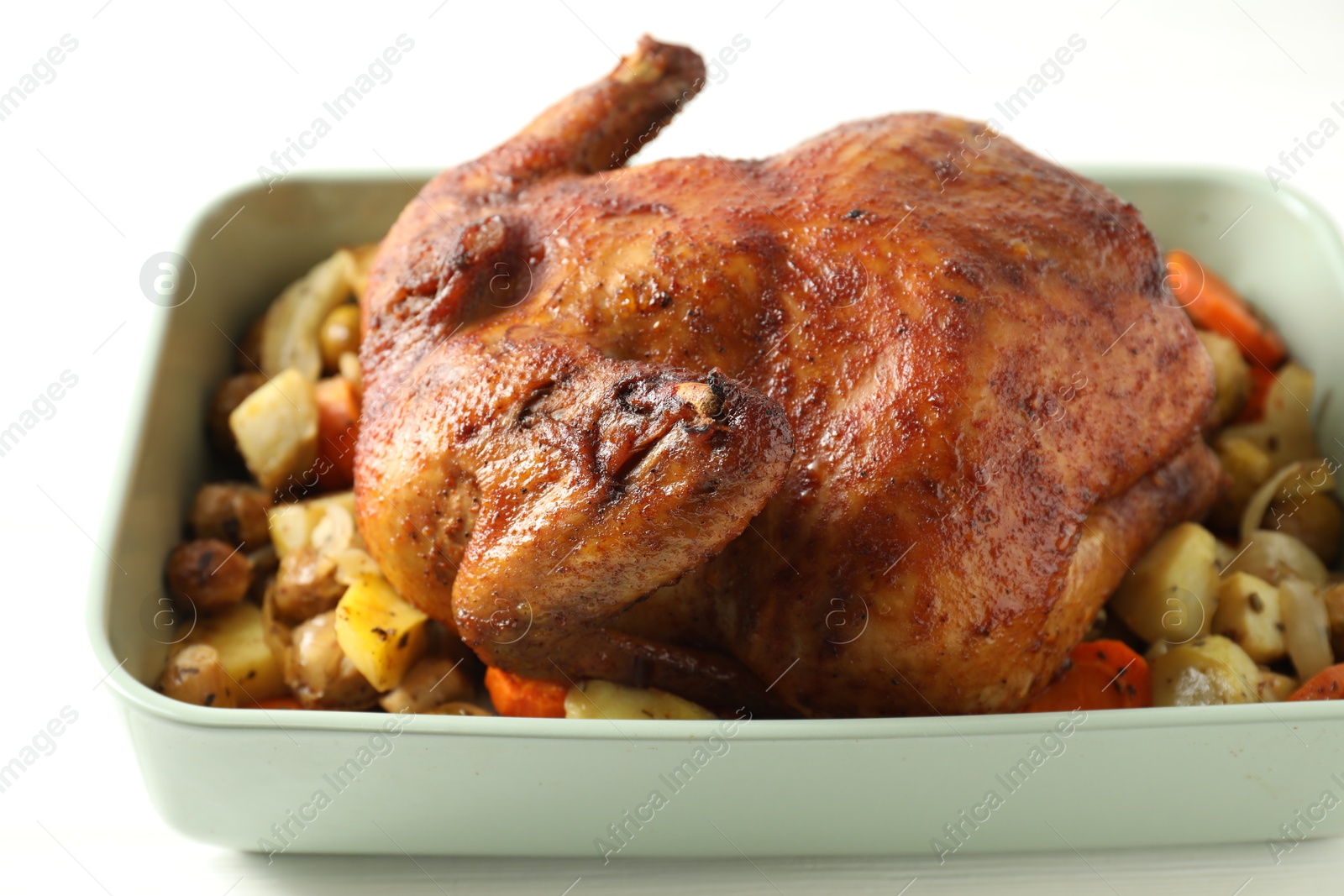 Photo of Delicious baked turkey and vegetables in baking dish on white table, closeup