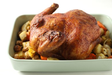 Delicious baked turkey and vegetables in baking dish on white table, closeup