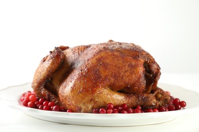 Photo of Delicious baked turkey and cranberries on white table, closeup