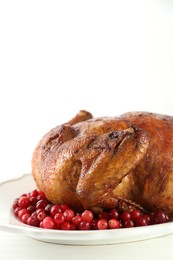 Delicious baked turkey and cranberries on white table, space for text