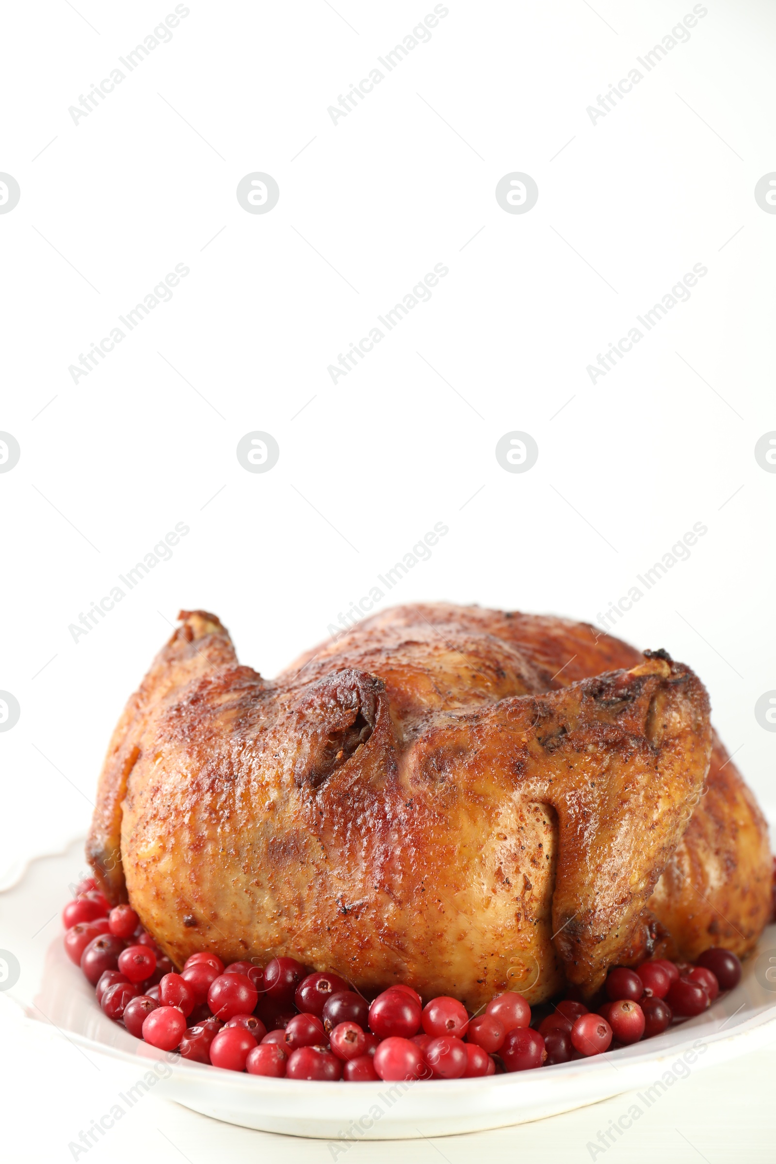 Photo of Delicious baked turkey and cranberries on white table, space for text