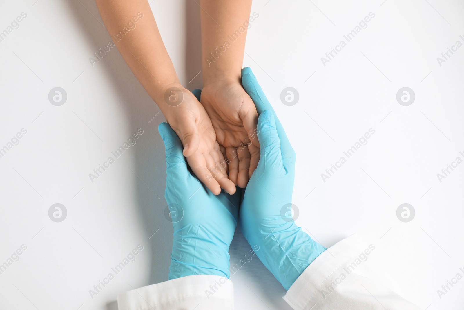 Photo of Doctor and child on white background, top view