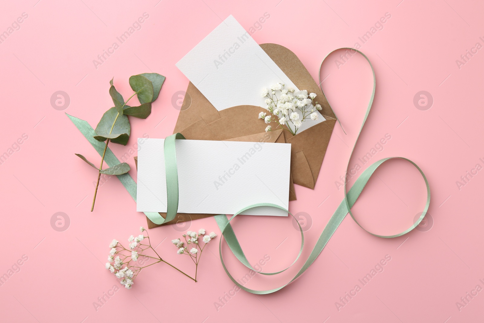 Photo of Flat lay composition with blank cards and ribbon on pink background