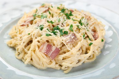 Photo of Delicious pasta Carbonara with bacon on plate, closeup