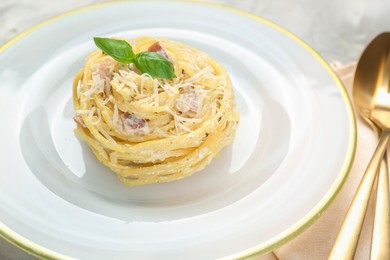 Photo of Plate with delicious pasta Carbonara on table, closeup