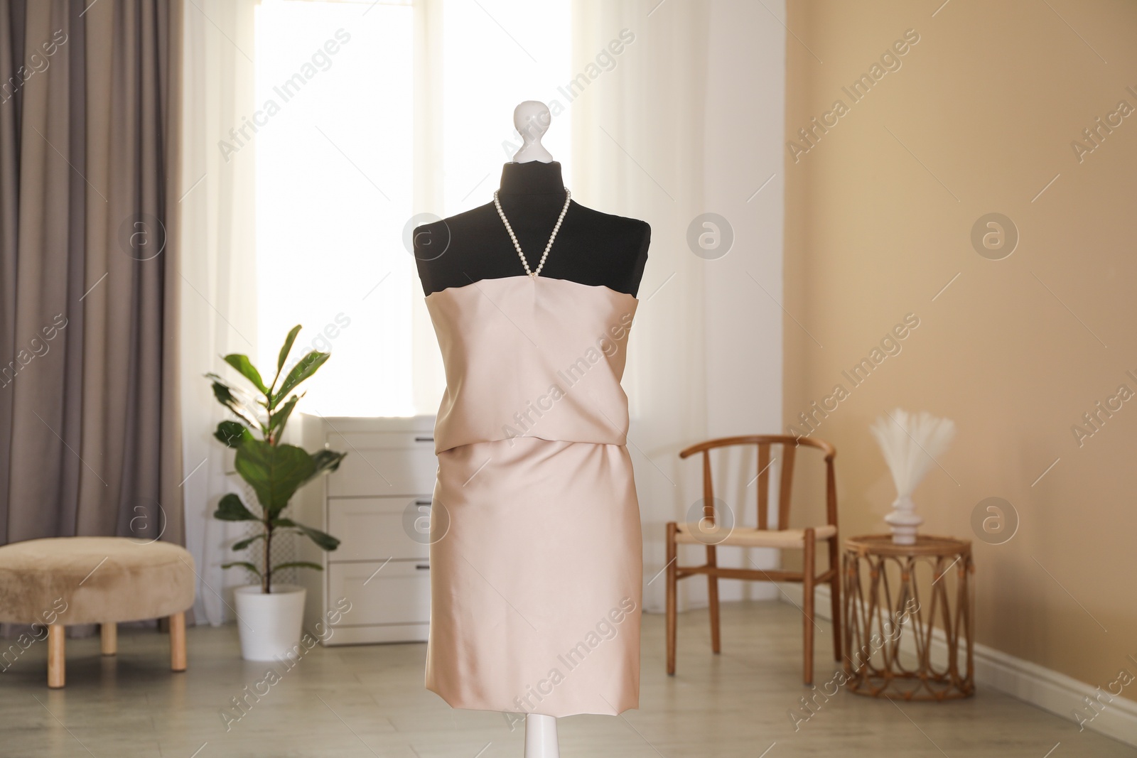 Photo of One female mannequin with unfinished dress in workshop