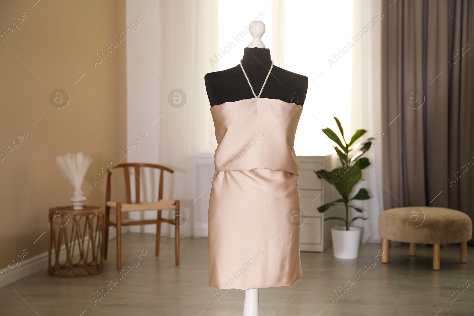 Photo of One female mannequin with unfinished dress in workshop